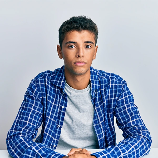 Young man appearing anxious looking at the camera