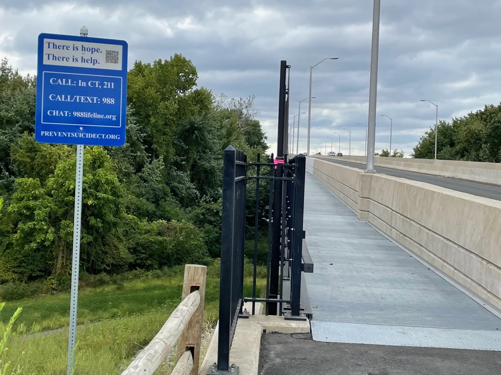 A sign near the Putnam Bridge reads 'There is hope - There is help' with the 988 contact info.
